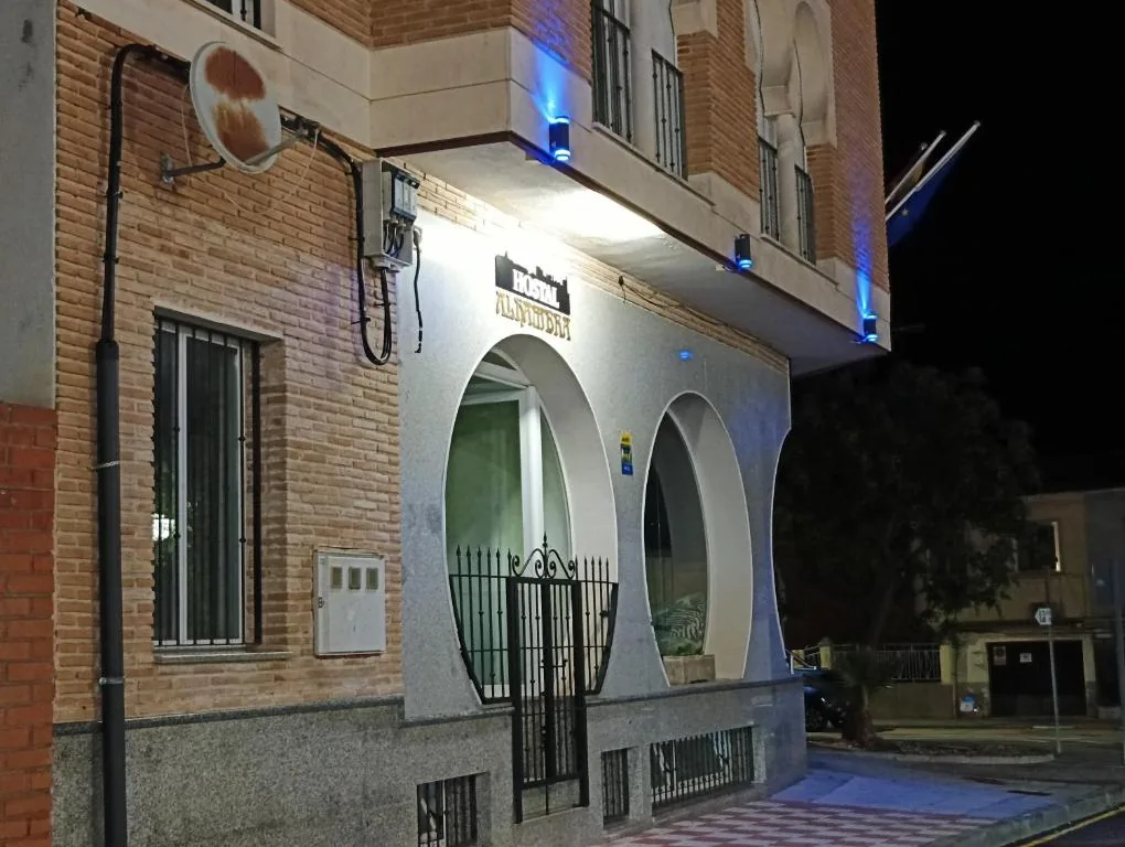 Hostal Alhambra illuminated entrance at night